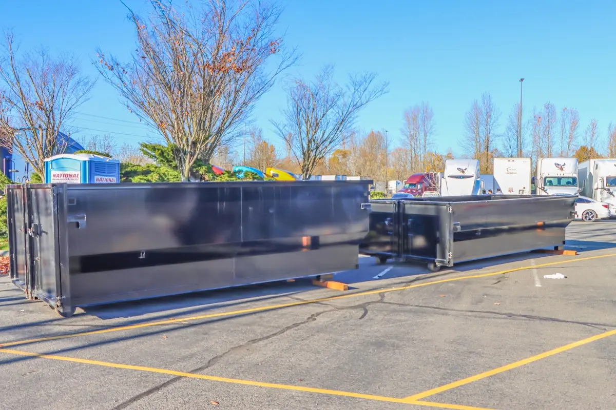 Professional dumpster rental service with roll-off container on residential driveway in Batesville